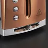 Close-up of a copper toaster with chrome accents, showing the browning control dial and crumb tray. Produktbild-Vorschau