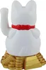 A white Maneki-neko cat figurine with a red collar sits on a golden base made of stacked coins. Produktbild-Vorschau