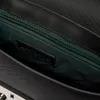 A close-up view of the interior of a black bag, showing a zipper and a brand label. Anteprima dell’immagine prodotto