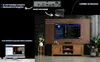 A living room scene with a TV, media console, and a computer displaying content, illustrating the product's features. Produktbild-Vorschau
