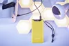 A yellow power bank is charging a VR headset, with hexagonal LED lights in the background. Voir les images du produit