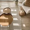 A living room scene with a rug, coffee table, and armchair. Voir les images du produit