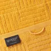 Close-up of a yellow towel with a textured pattern and a label. Produktbild-Vorschau