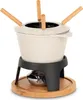 A fondue set on a wooden base. Voir les images du produit