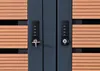 Close-up of two combination locks on a dark gray surface, with wooden slats visible on the sides. Produktbild-Vorschau