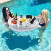 Two women are enjoying drinks and snacks from an inflatable pool tray while in a swimming pool. Náhled obrázku produktu