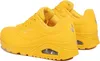 A pair of yellow Skechers sports shoes are shown from a side-angle. Voir les images du produit