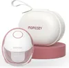 A pink and white Momcozy M6 mobile breast pump and its carrying case are displayed on a pink stand against a white background. Voir les images du produit