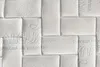 A close-up view of a quilted mattress surface with embossed text and patterns. Náhľad obrázku produktu