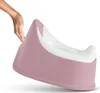 A hand is holding a pink and white potty training seat. Náhľad obrázku produktu