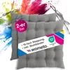 Two gray seat cushions are shown with a colorful powder explosion in the background.