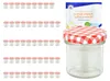 A collection of small glass jars with red and white checkered lids, and one jar in the foreground with a product box behind it. Podgląd zdjęcia produktu
