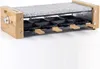 A raclette grill with a granite stone top and wooden accents, shown on a white background. Produktbild-Vorschau