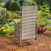A wicker garden chair is placed on a wooden deck in a lush garden setting. Produktbild-Vorschau