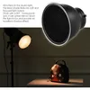 A studio light with a honeycomb grid attached, illuminating a small bag on a table. Podgląd zdjęcia produktu