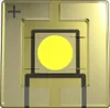 A close-up, top-down view of a yellow LED component on a metallic surface. Produktbild-Vorschau