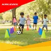 Children playing soccer in a park with cones and hoops. Produktbild-Vorschau