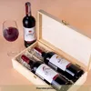A wooden box for two wine bottles, with one bottle standing next to it and a glass of red wine. Produktbild-Vorschau