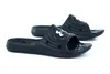 A pair of black Under Armour slides on a white background. Anteprima dell’immagine prodotto