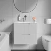 A modern bathroom vanity with a sink and drawers, a mirror, and a toilet. Náhled obrázku produktu