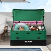 An open green storage box filled with various items like pool floats, pillows, and sports balls, placed outdoors near a pool. Produktbild-Vorschau