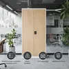 A modern office environment with a tall cabinet in the center, surrounded by plants and office furniture. Icons at the bottom suggest different use cases. Voir les images du produit
