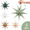 A collection of five paper star decorations in various colors, with one being held by a hand. Produktbild-Vorschau