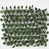 A close-up view of an expandable garden fence covered in artificial ivy leaves, set against a white background. Náhled obrázku produktu