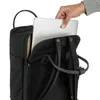 A hand is placing a laptop into a black backpack. Produktbild-Vorschau