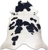 A cowhide rug with black and white markings, laid flat on a white background. Produktbild-Vorschau