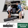 Two men are loading luggage and a long black bag into the back of a white SUV. Anteprima dell’immagine prodotto