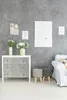 A living room scene with a dresser, stools, and wall art. Náhled obrázku produktu