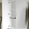 An open white cabinet with shelves, showing folded clothes on one shelf. Produktbild-Vorschau