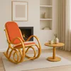 A cozy living room scene with a rocking chair, fireplace, and side table. Produktbild-Vorschau