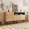 A modern living room setting with a wooden sideboard, artwork, and a lamp. Anteprima dell’immagine prodotto