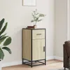 A wooden cabinet with a black metal frame is placed in a room next to a large plant and a sofa. Anteprima dell’immagine prodotto
