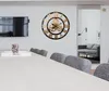 A modern dining room with a large wall clock and a TV. Produktbild-Vorschau