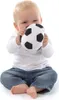A baby sitting down and playing with a soft soccer ball. Produktbild-Vorschau