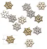 A collection of small, glittery snowflake-shaped confetti pieces in gold, silver, and white. Produktbild-Vorschau