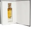 A perfume bottle is presented in an open box that resembles a book. Anteprima dell’immagine prodotto