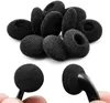 A pile of black foam earbud covers and two earbud covers attached to earbuds, all on a white background. Produktbild-Vorschau