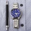 A watch and pen are laid out on a blue dotted shirt. Náhľad obrázku produktu