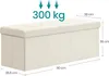 A cream-colored storage ottoman with dimensions and weight capacity indicated. Produktbild-Vorschau