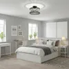 A bedroom with a bed, desk, and a ceiling light. Voir les images du produit