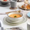 A table setting with soup, pasta, and drinks, suggesting a meal. Náhled obrázku produktu