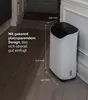 A white dehumidifier is placed in a corner of a room, next to a wall and a doorway. Dimensions are indicated with lines and text. Anteprima dell’immagine prodotto