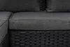 A close-up view of a section of a dark gray upholstered sofa with a black woven base. Náhled obrázku produktu