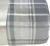 A close-up view of a plaid blanket with a satin trim. Produktbild-Vorschau