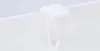 A close-up of a white hook attached to a white surface. Produktbild-Vorschau