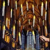 A hand holding a wand is about to cast a spell on floating LED candles in a grand hall with stained glass windows. Produktbild-Vorschau